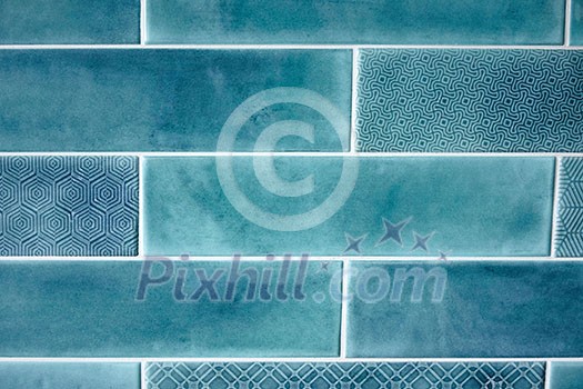 Background and texture of blue rectangular tiles with a pattern on some tiles Background and texture of blue rectangular tiles with a pattern on some tiles