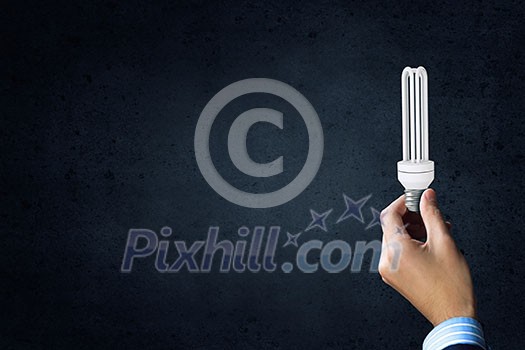 Close up of businessman hand holding glass light bulb Close up of businessman hand holding glass light bulb