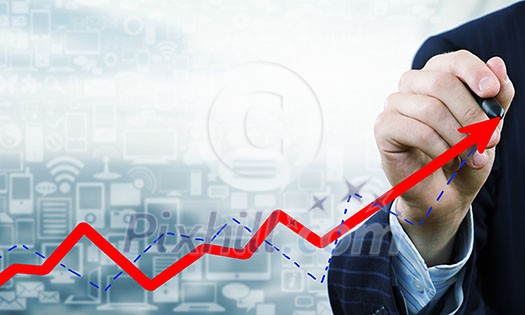 Close up of businessman drawing increasing graph with marker on media screen Close up of businessman drawing increasing graph with marker on media screen