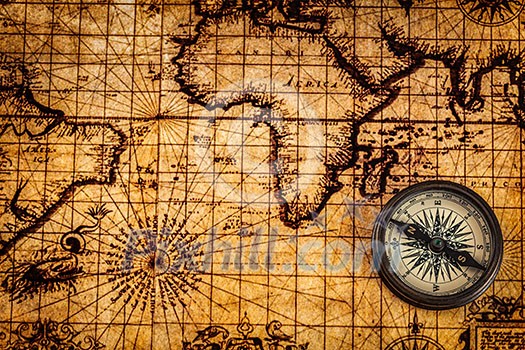 Travel geography navigation concept background - old vintage retro compass on ancient world map Travel geography navigation concept background - old vintage retro compass on ancient world map
