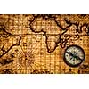 Travel geography navigation concept background - old vintage retro compass on ancient world map