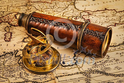 Travel geography navigation concept background - old vintage retro compass with sundial and spyglass on ancient world map Travel geography navigation concept background - old vintage retro compass with sundial and spyglass on ancient world map