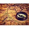 Travel geography navigation concept background - vintage retro effect filtered hipster style image of old vintage retro compass on ancient world map