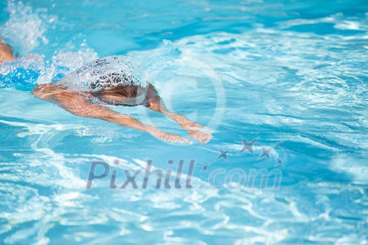 Pretty female swimmer in a pool, getting her daily dose of exercise without stressing her joints Pretty female swimmer in a pool, getting her daily dose of exercise without stressing her joints