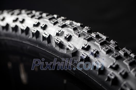Modern MTB race mountain bike tyre isolated on black background in a studio Modern MTB race mountain bike tyre isolated on black background in a studio
