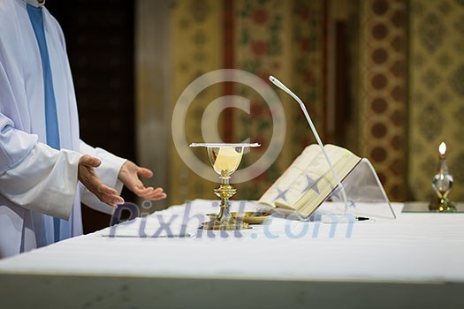 Priest during a wedding ceremony/nuptial mass Priest during a wedding ceremony/nuptial mass
