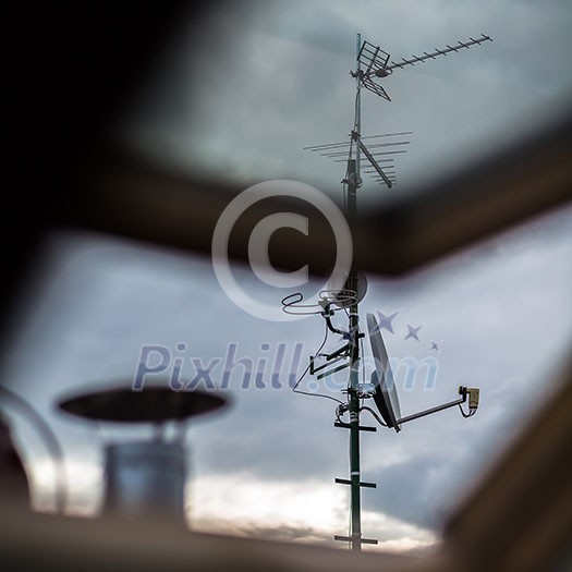 Antennas and a satellite dish on a roof Antennas and a satellite dish on a roof