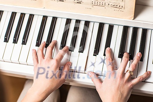 Playing Piano (shallow DOF; color toned image) Playing Piano (shallow DOF; color toned image)