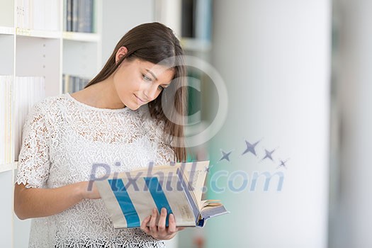 Pretty, young college student looking for a book in the library, studying for her exam Pretty, young college student looking for a book in the library, studying for her exam