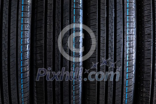 Stack of brand new high performance car tires on clean high-key white studio background Stack of brand new high performance car tires on clean high-key white studio background