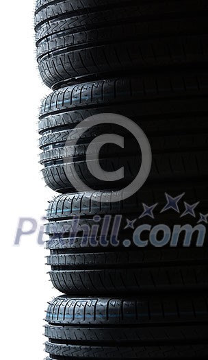 Stack of brand new high performance car tires on clean high-key white studio background Stack of brand new high performance car tires on clean high-key white studio background