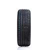 Stack of brand new high performance car tires on clean high-key white studio background