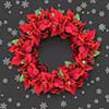 christmas wreath from poinsettia on grey background with snowflakes