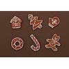 Homemade Gingerbread cookies with different shapes isolated on a brown background. Christmas background
