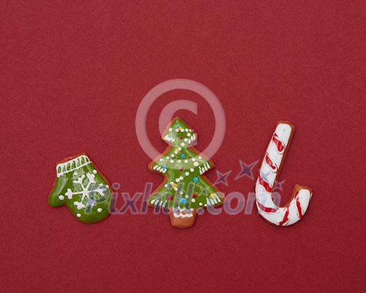 Christmas gingerbread cookies with color icing on a red background Christmas gingerbread cookies with color icing on a red background