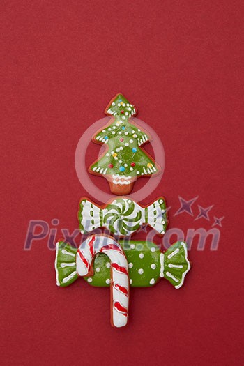 Christmas card with Christmas tree from ginger biscuits on a red background Christmas card with Christmas tree from ginger biscuits on a red background