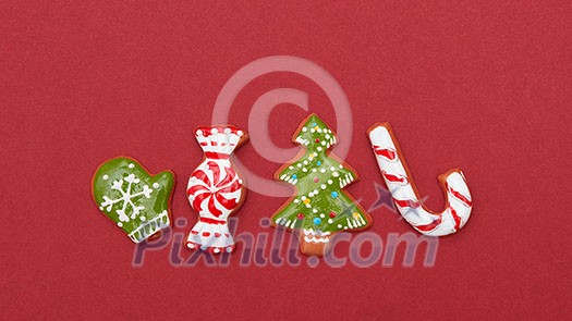 Four Christmas cookies on a red background with space for text Four Christmas cookies on a red background with space for text