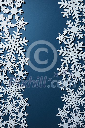 Christmas postcard with white snowflakes on blue background. Christmas postcard with white snowflakes on blue background.
