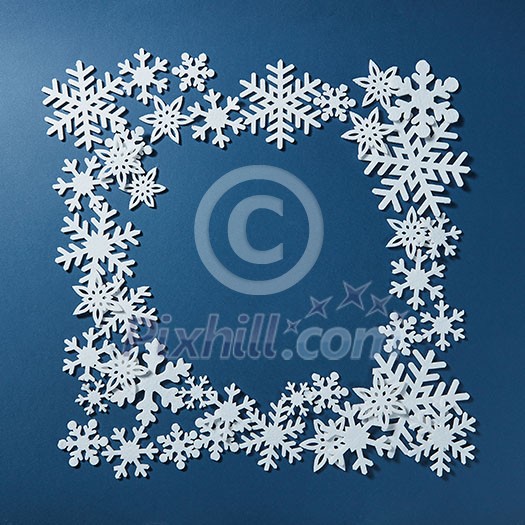 Frame of Christmas snowflakes on blue background Frame of Christmas snowflakes on blue background