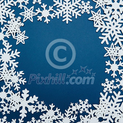 Christmas frame background with snowflakes. Isolated on a blue background with copy space Christmas frame background with snowflakes. Isolated on a blue background with copy space