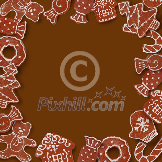 Christmas card with frame made of ginger cookies on a brown background Christmas card with frame made of ginger cookies on a brown background