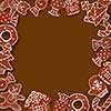 Christmas card with frame made of ginger cookies on a brown background