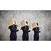 Unrecognizable business people with carton boxes on head