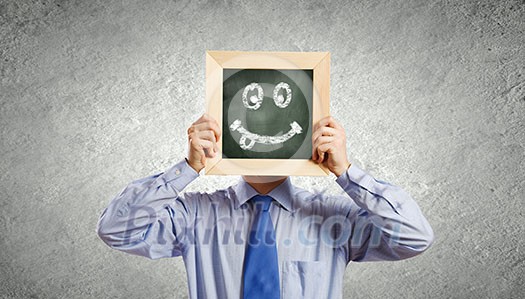 Young smiling businessman holding chalkboard with smiley Young smiling businessman holding chalkboard with smiley