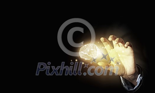 Close up of businessman holding digital image of brain in palm Close up of businessman holding digital image of brain in palm