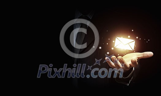 Close up of businessman holding email icon in palm Close up of businessman holding email icon in palm