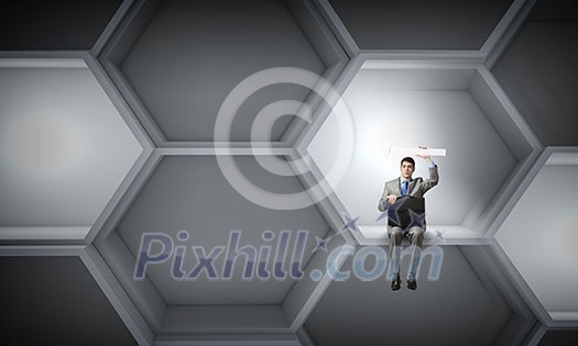 Young smiling businessman sitting with briefcase in hands Young smiling businessman sitting with briefcase in hands