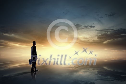 Rear view of businessman against sunrise scene Rear view of businessman against sunrise scene