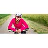 Pretty, young female biker outdoors on her mountain bike (shallow DOF; selective focus)