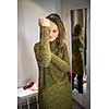 Young woman shopping happily in a fashion store, trying on some clothes she likes, disagreeing sometimes with her boyfriend's opinion (color toned image; shallow DOF)