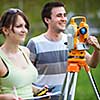 Two young land surveyors at work
