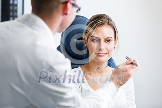 Optometry concept - pretty young woman having her eyes examined by an eye doctor/optometrist (color toned image; shallow DOF) Optometry concept - pretty young woman having her eyes examined by an eye doctor/optometrist (color toned image; shallow DOF)