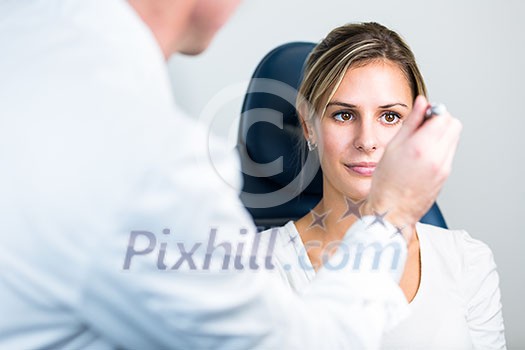 Optometry concept - pretty young woman having her eyes examined by an eye doctor/optometrist (color toned image; shallow DOF) Optometry concept - pretty young woman having her eyes examined by an eye doctor/optometrist (color toned image; shallow DOF)