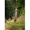 Active senior hiking in high mountains - enjoying his retirement in an active way