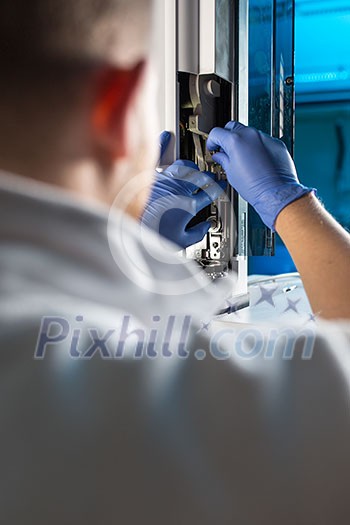 Senior male researcher carrying out scientific research in a lab (shallow DOF; color toned image) Senior male researcher carrying out scientific research in a lab (shallow DOF; color toned image)