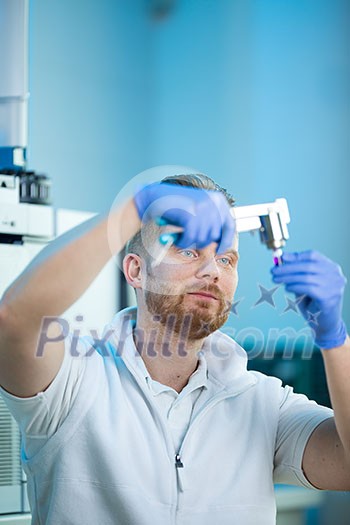 Senior male researcher carrying out scientific research in a lab (shallow DOF; color toned image) Senior male researcher carrying out scientific research in a lab (shallow DOF; color toned image)