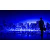 Businessman standing with back against night city panoramic view