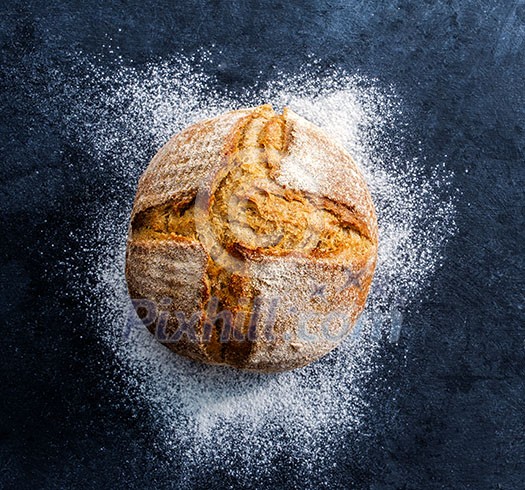 Fresh homemade bread over dark table.Top view.