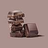 pieces of delicious chocolate on a brown background isolated