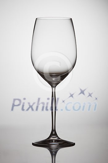 empty transparent wine glass on a table on a white background