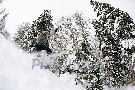 Snowboarder doing a jump and free ride on powder snow at winter season Snowboarder doing a jump and free ride on powder snow at winter season