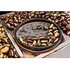 Fried chestnuts on the street. Street food. Roasted chestnuts served in a special perforated chestnut pan.
