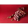 bunch of ripe red grapes with leaves isolated on red background