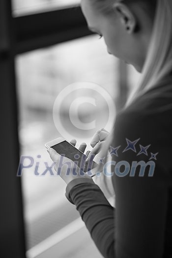business woman at office using smart phone to surf internet and type messages business woman at office using smart phone to surf internet and type messages