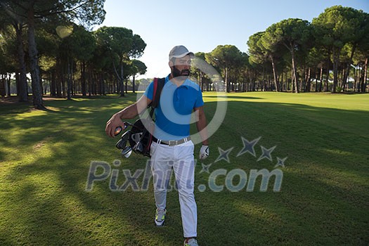 handsome middle eastern golf player carrying and bag and walking at course on beautiful morning sunrise handsome middle eastern golf player carrying and bag and walking at course on beautiful morning sunrise