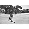 handsome middle eastern golf player carrying and bag and walking at course on beautiful sunset